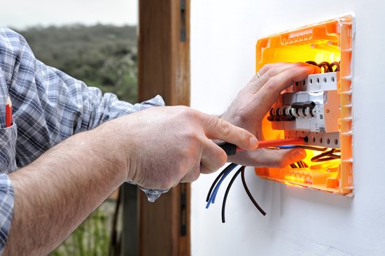 Electrician technician repairs the electrical panel of a residen two light bulbs fighting scene