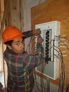 emergency electrician fixing the wires in the panel box