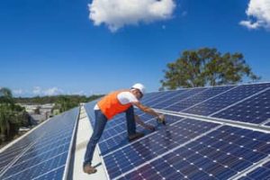 Ajax Electrical worker installing solar panels