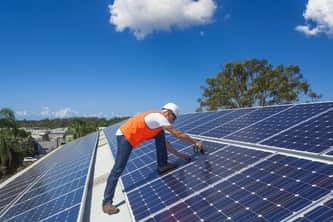 installing solar panels man installing solar panels